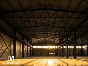 Interior of an insulated I-beam steel building with warm lighting, showing roof and wall insulation for energy efficiency.